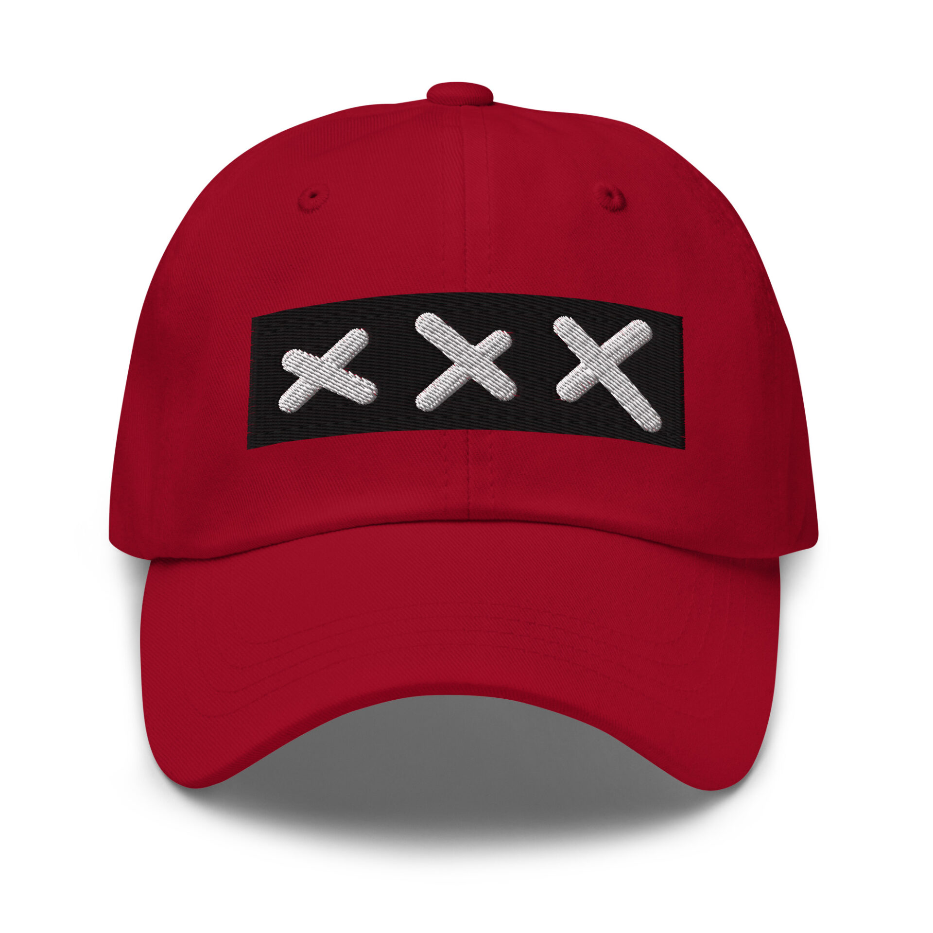 A classic XXX Dad Cap in red, showcasing a black rectangular patch with three white embroidered Amsterdam Crosses in a row on the front.