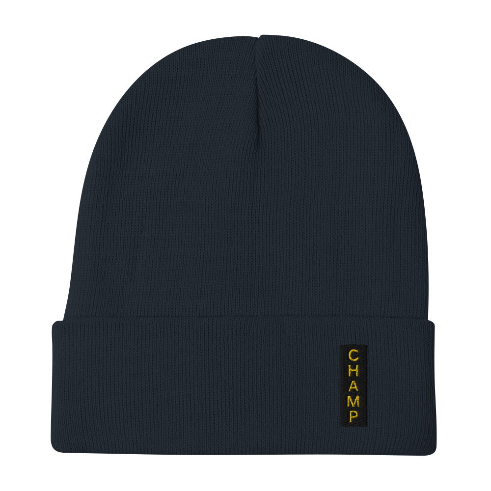 The Subtle & Mighty CHAMP Embroidered Beanie features a dark color, folded brim, and CHAMP in yellow on a vertical patch. The Subtle & Mighty CHAMP Embroidered Beanie features a dark color, folded brim, and CHAMP in yellow on a vertical patch.
