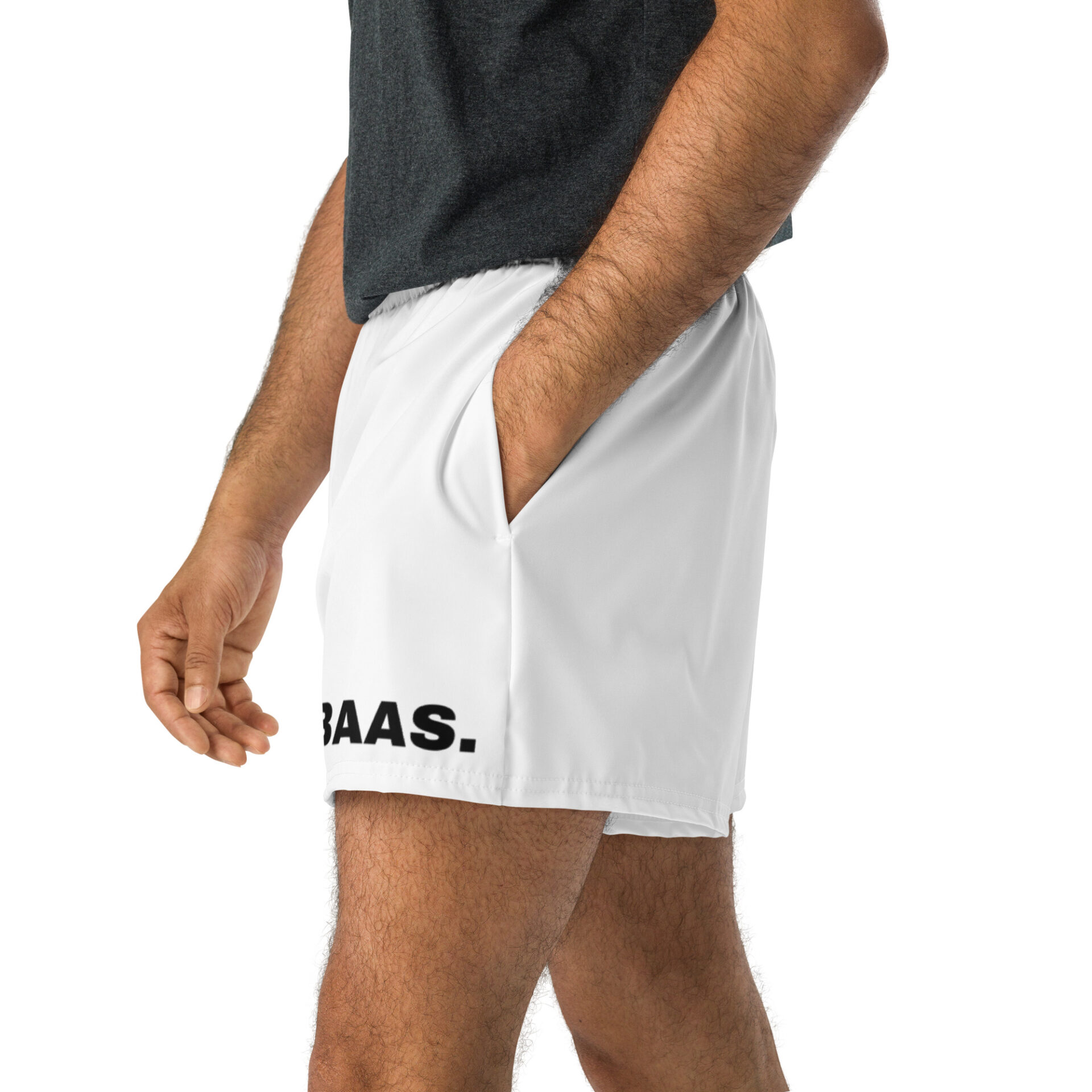 A person in white BAAS Athletic Shorts, adorned with BAAS on one leg, stands casually with a hand in their pocket, paired with a dark gray shirt against a plain white background.