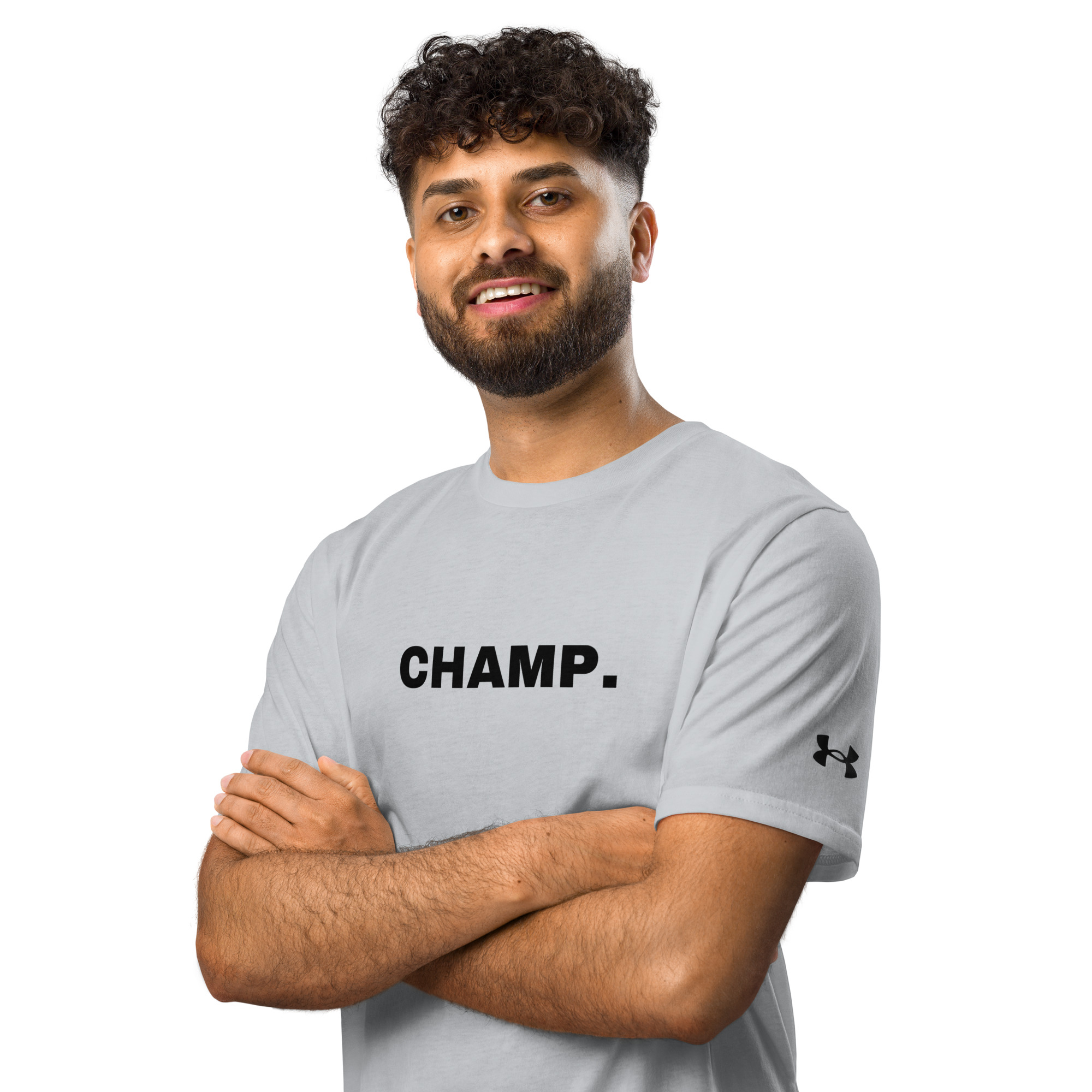 A man with curly hair and a beard smiles with arms crossed, wearing a light gray Under ArmourⓇ athletic t-shirt embroidered with "CHAMP" in black letters and the logo on the sleeve. A man with curly hair and a beard smiles with arms crossed, wearing a light gray Under ArmourⓇ athletic t-shirt embroidered with "CHAMP" in black letters and the logo on the sleeve.