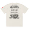 An oversized faded t-shirt in white featuring bold black text on the back with motivational phrases about dreams, including "You have to eat the dream, sleep the dream," and "You gotta be possessed with the dream.