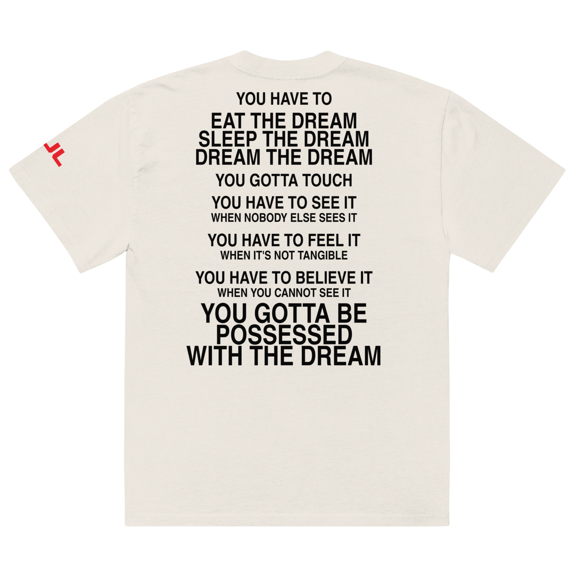 An oversized faded t-shirt in white featuring bold black text on the back with motivational phrases about dreams, including "You have to eat the dream, sleep the dream," and "You gotta be possessed with the dream.